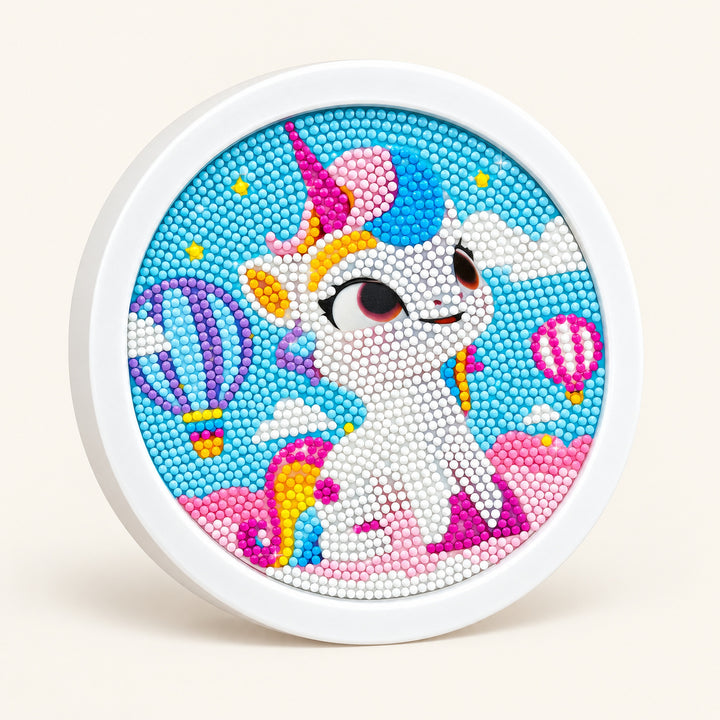 Unicorn Diamond Painting Kit with Round Frame — studio product photograph on a warm ivory background