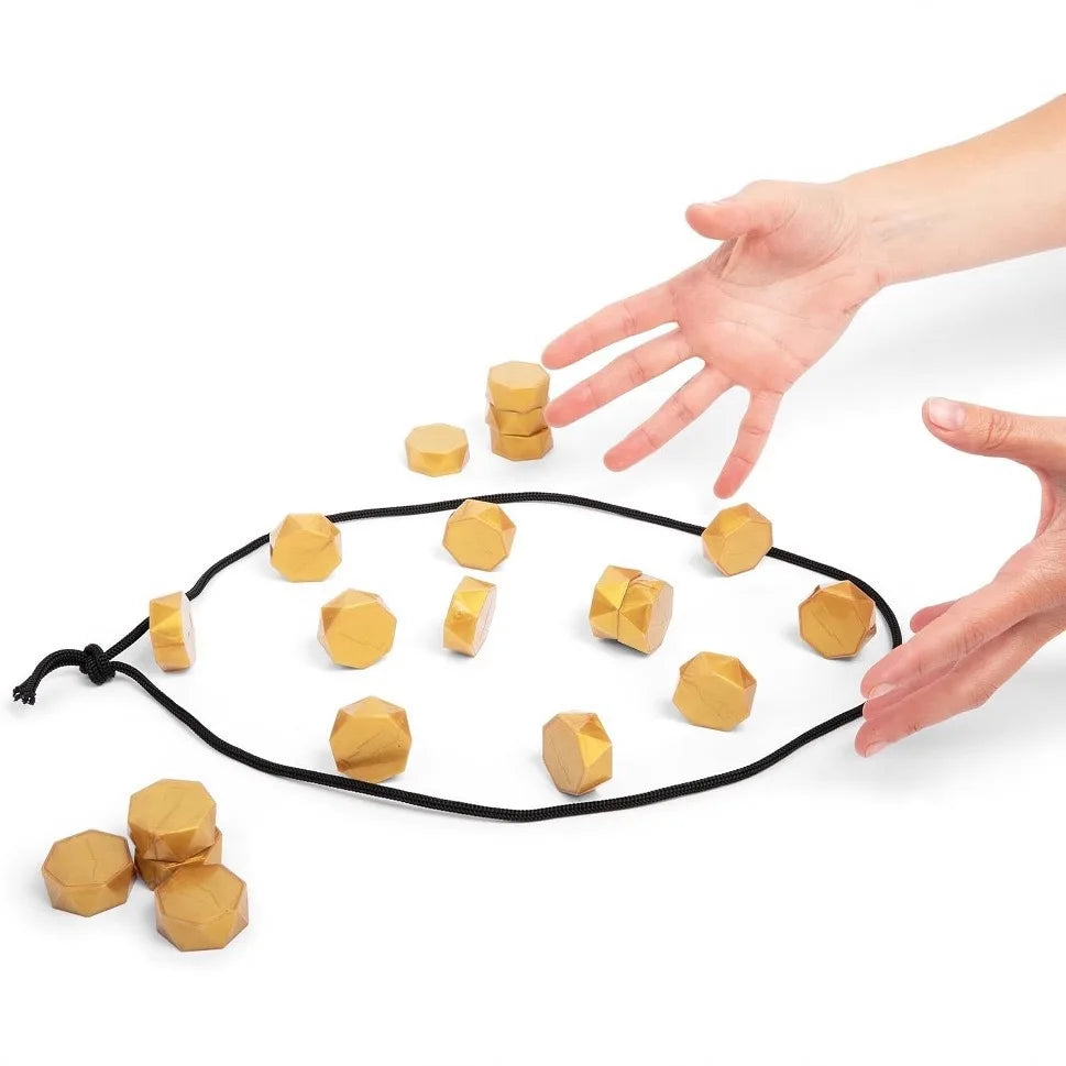 Hands playing the magnetic strategy game with golden pieces