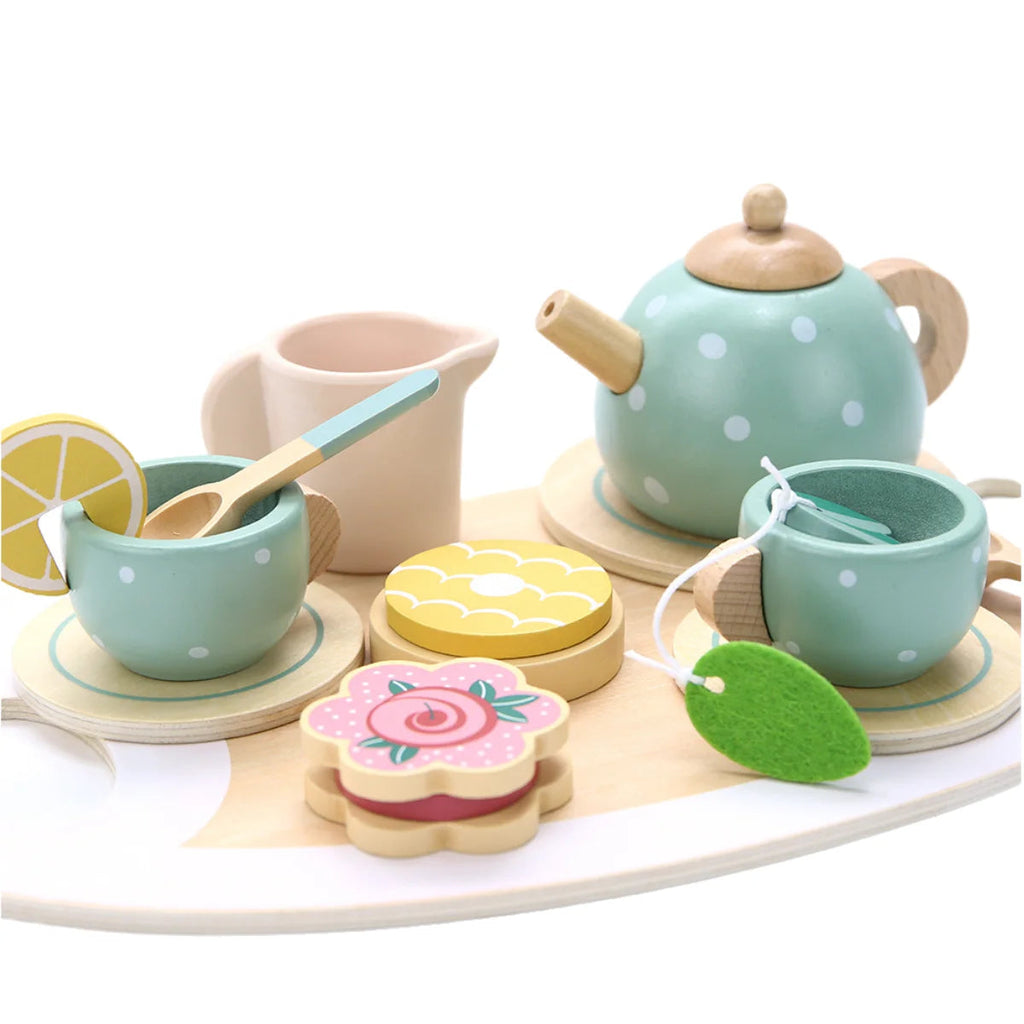 Close-up of the wooden teapot, cups and pretend cakes