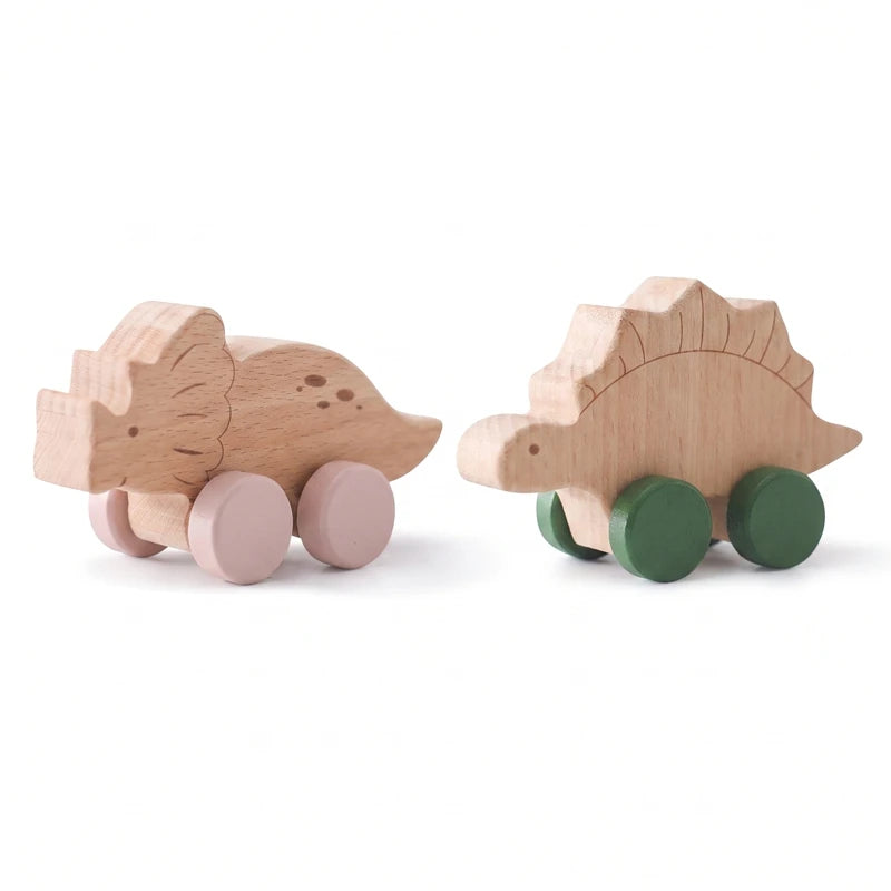 Close-up of the wooden triceratops and stegosaurus push-along cars